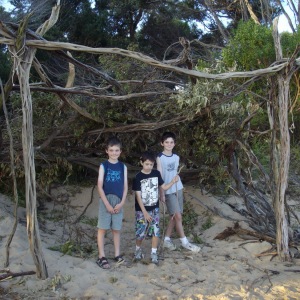 Connor, Xander and Kyle under a beach shelter